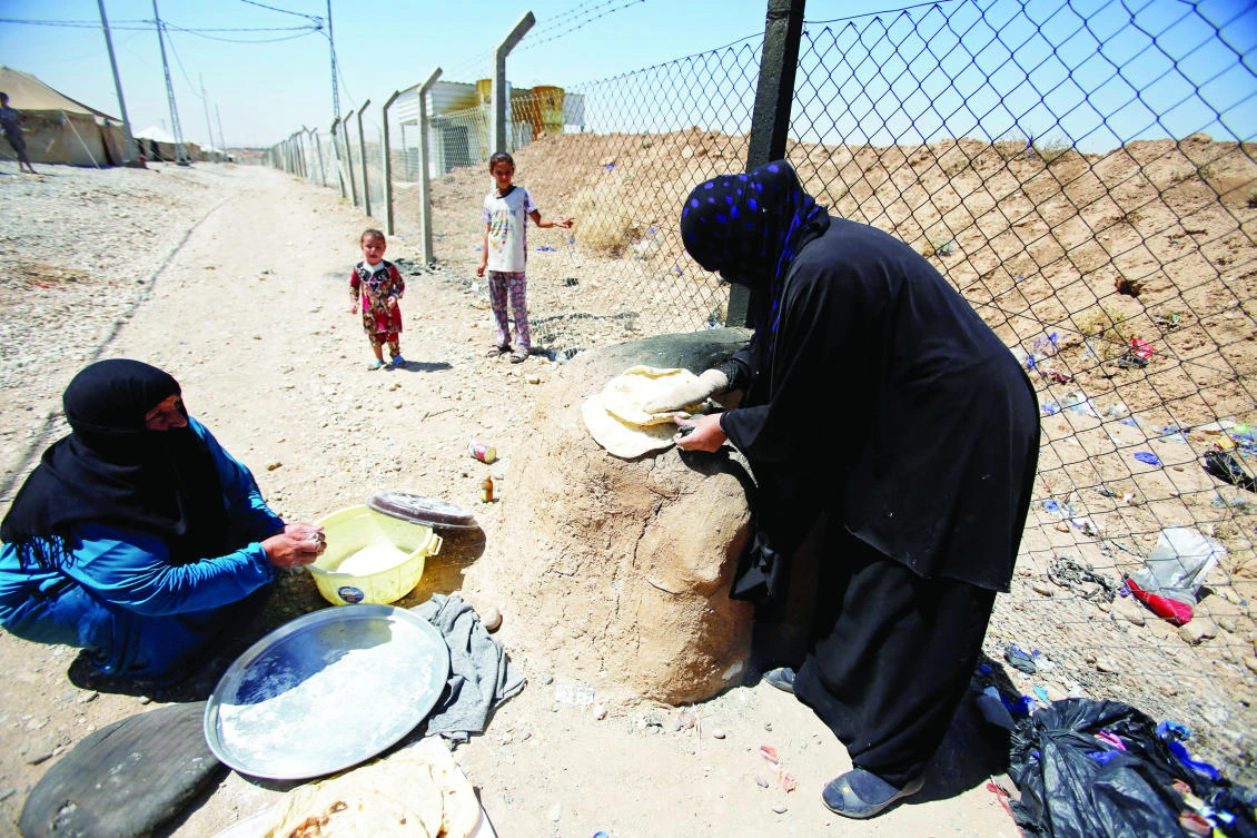 Displaced Iraqi women from Tal Afar make bread in Salamya camp, east of Mosul, Iraq. (Reuters)