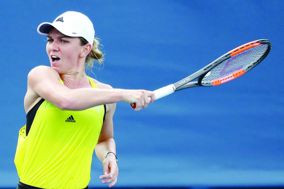 Simona Halep of Romania returns a shot to Anastasija Sevastova of Latvia during
Day 6 of the Western and Southern Open at the Linder Family Tennis Center on Thursday
in Mason, Ohio. (AFP)