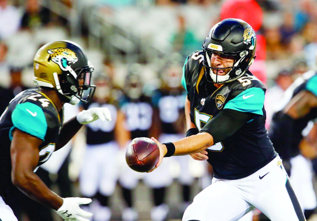 Jacksonville Jaguars quarterback Blake Bortles (5) hands off to running back T.J. Yeldon (24) during the first quarter of an NFL football game against the Tampa Bay Buccaneers at EverBank Field in Jacksonville, Fla. (USA TODAY Sports)