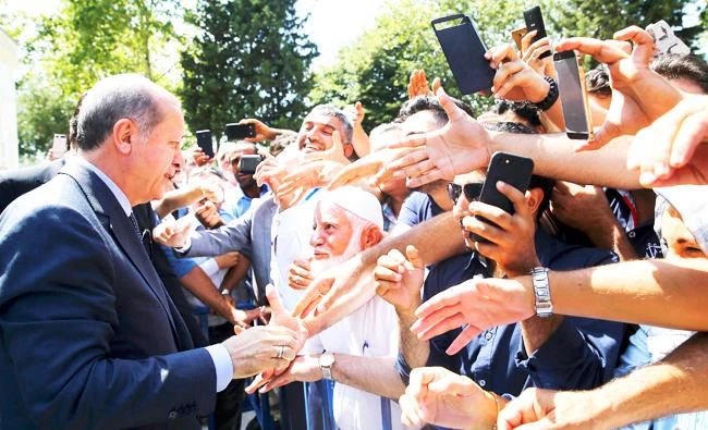 Turkey’s President Recep Tayyip Erdogan talks to supporters after attending Friday prayers in Istanbul. (AP)
