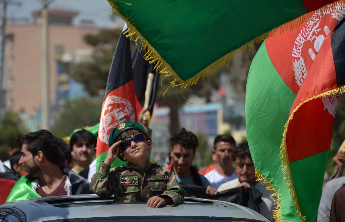 An Afghan boy salutes while dressed in military gear during celebrations to mark the country’s Independence Day in Mazar-i-Sharif, on August 19, 2017. (AFP)