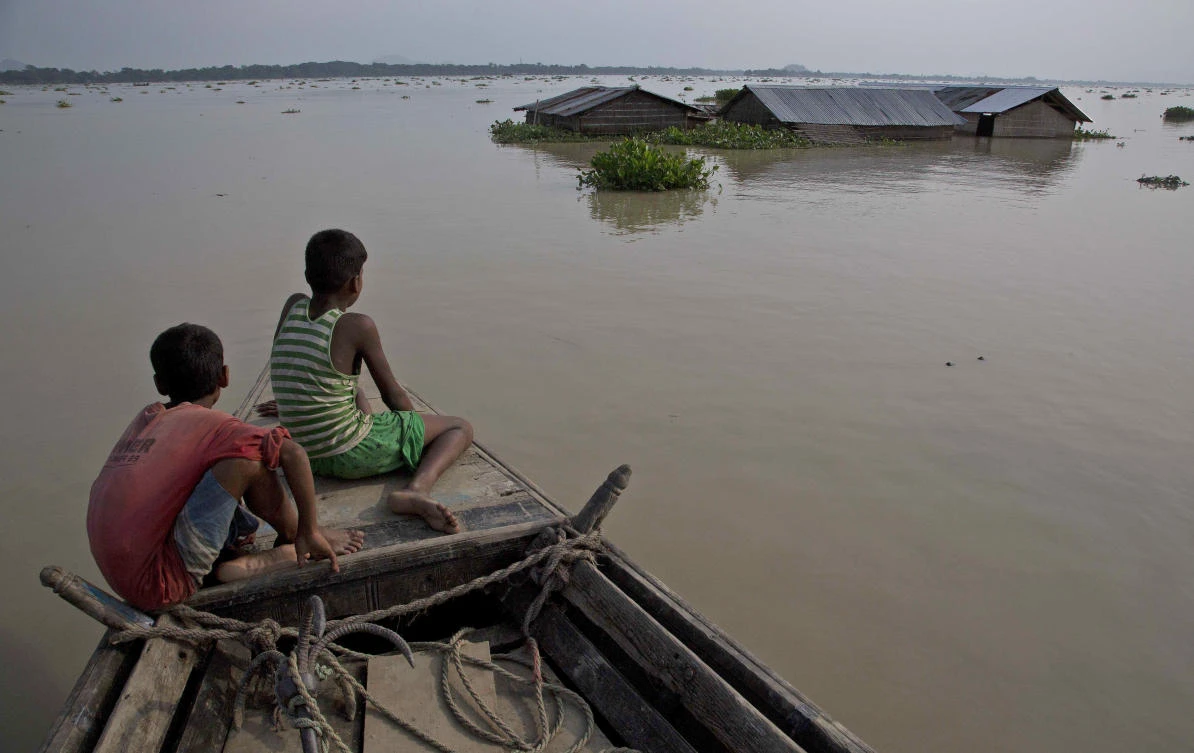 Flood affected villagers travel by boat in floodwaters in Morigaon district, east of Gauhati, northeastern state of Assam, on Aug. 15, 2017. (File Photo by AP)