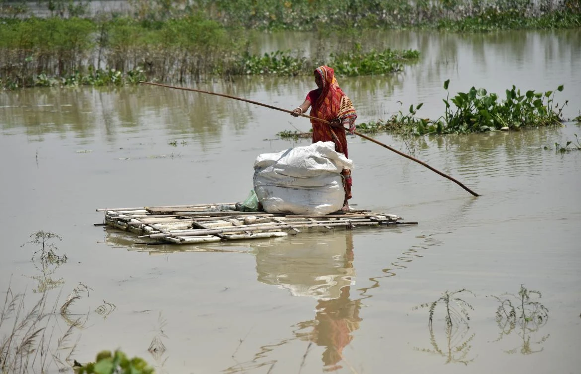 An Indian woman paddles a raft through floodwaters in Morigoan district, in India’s northeastern state of Assam, on August 17, 2017. At least 221 people have died and more than 1.5 million have been displaced by monsoon flooding across India, Nepal and Bangladesh, officials said August 15, as rescuers scoured submerged villages for the missing. (AFP)