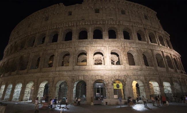 The lights of the ancient Colosseum are off to honor the victim of the deadly van attack in Barcelona, Spain, in Rome, on Aug. 18, 2017. On Saturday, Italy expelled two Morrocans and a Syrian man "for security reasons". (Claudio Peri/ANSA via AP)