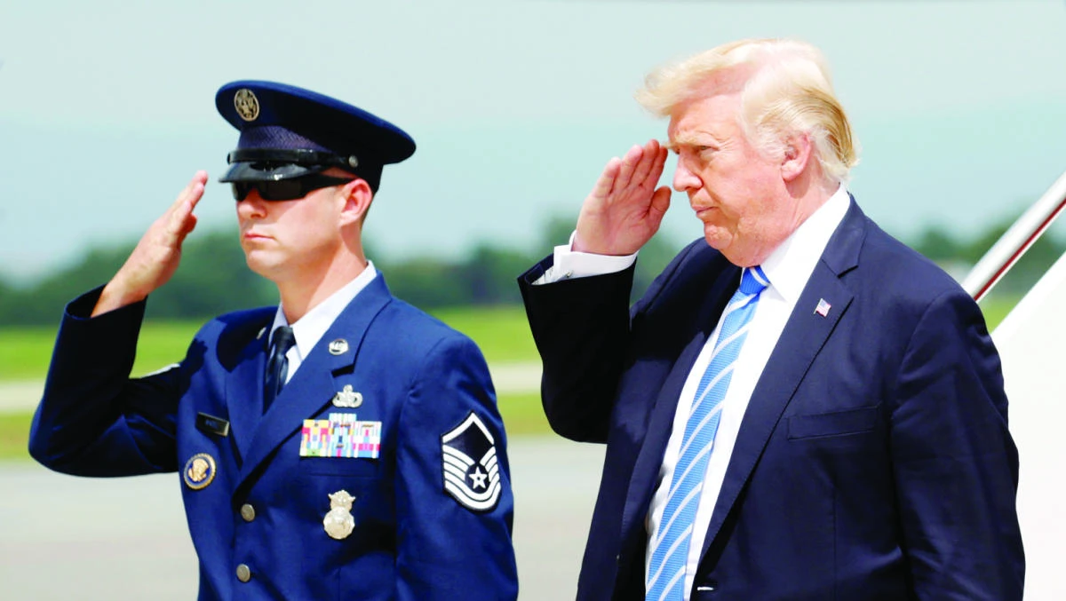 US President Donald Trump returns a salute as he steps from Air Force One, en route to nearby Camp David to meet with the National Security Council to try to agree on a strategy for Afghanistan, in Hagerstown, Maryland, Friday. (Reuters)