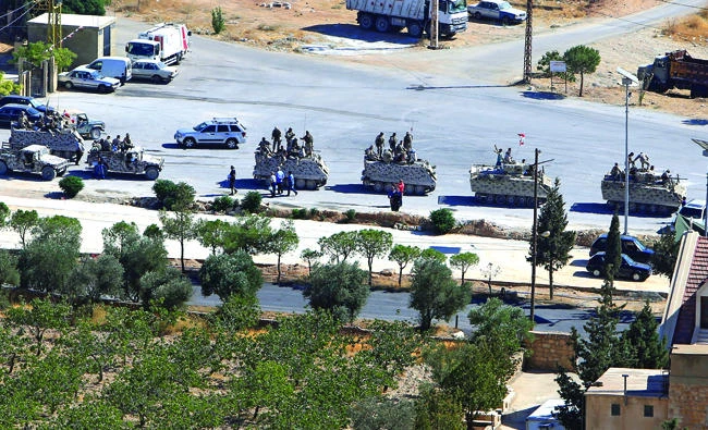 Lebanese soldiers in military tanks in the town of Ras Baalbek on Saturday. (Reuters)