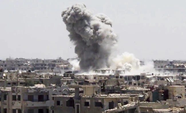 This frame grab from video provided on Aug. 13, 2017, by the Ghouta Media Center, a Syrian activist media group, shows smoke and debris rising after a Syrian government ground-to-ground rocket strikes the opposition-held town of Ain Terma, in the Eastern Ghouta suburb of Damascus, Syria. (AP)