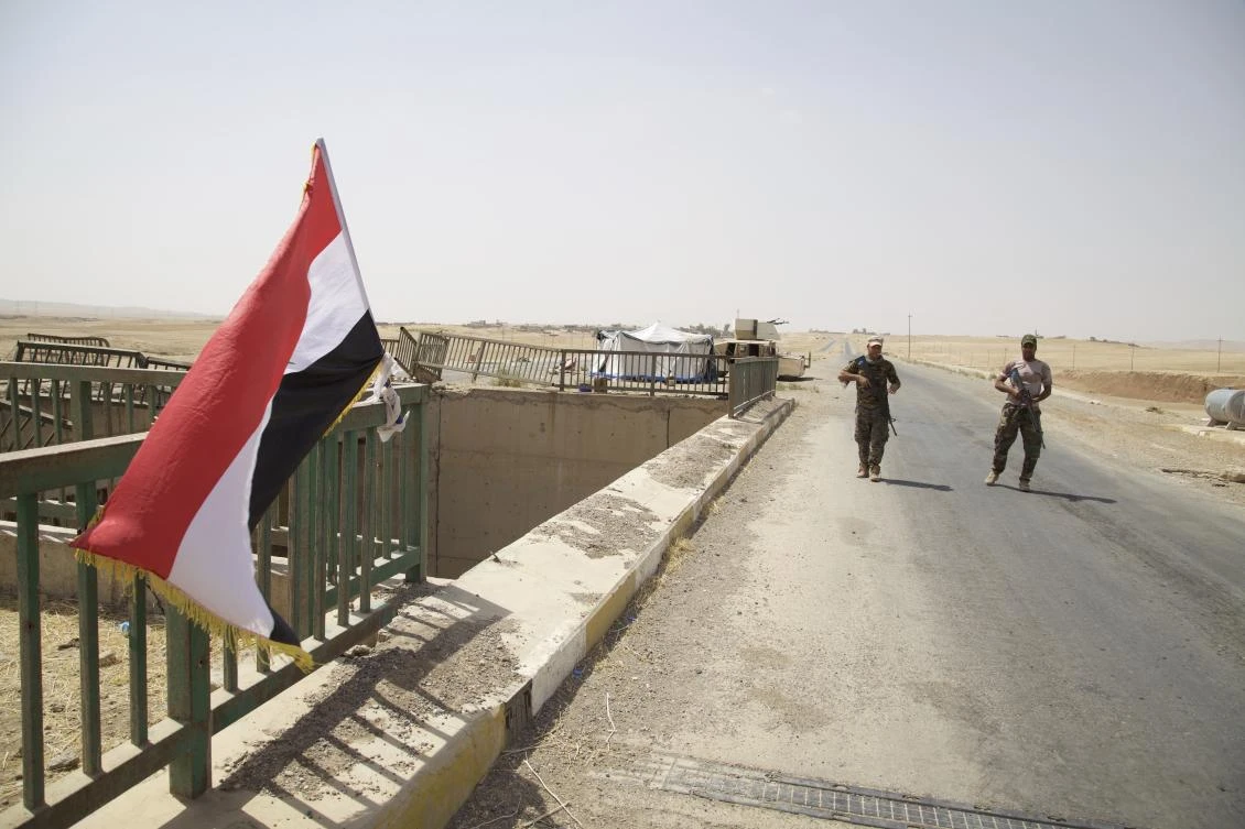 Two Iraqi soldiers are guarding a bridge on the road to Tel Afar in this August 14, 2017, photo. The Iraqi government has begun to deploy forces around the town in preparation for an attack against one of the last urban centers under the Daesh group control in northern Iraq. (AP Photo/Balint Szlanko)