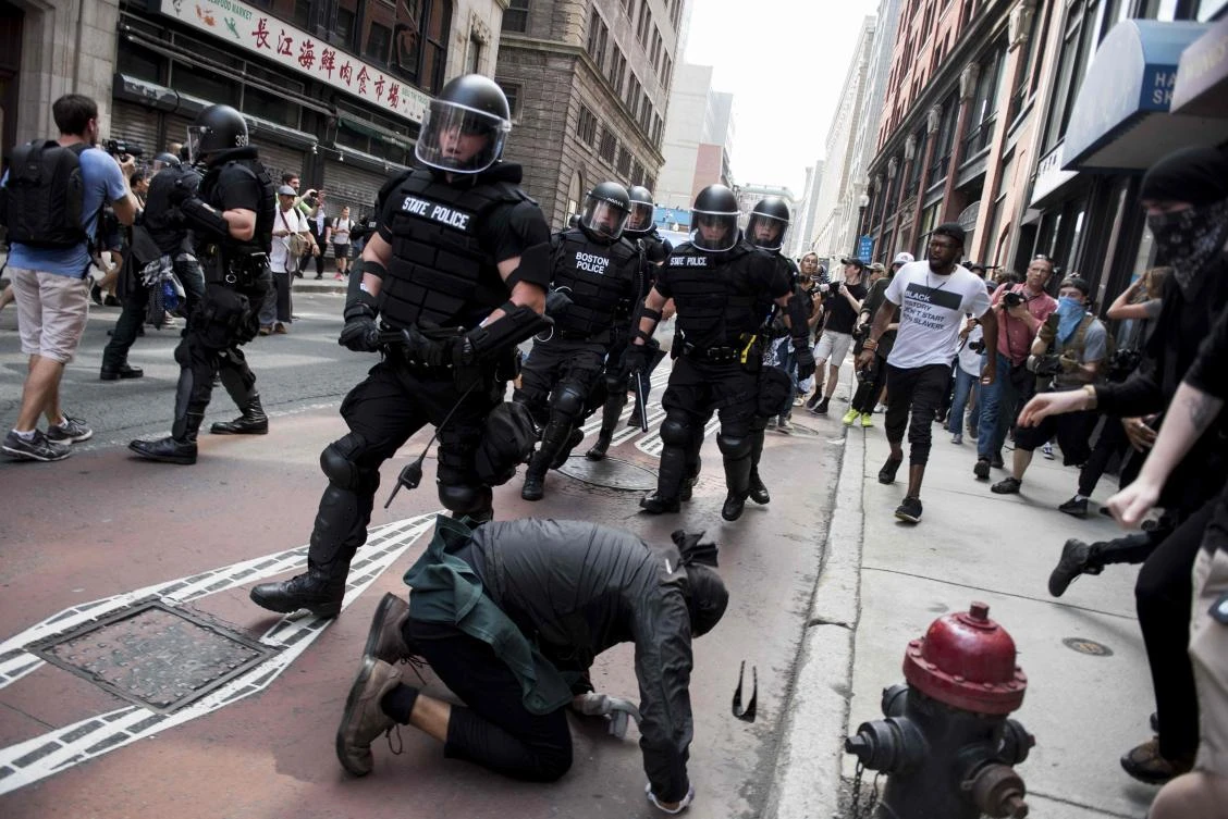 Counter-protesters of the Boston 'Free Speech' Rally clash with police as they are moved back at Boston Commons on August 19, 2017, in Boston. Thousands of anti-racism demonstrators flooded the streets of Boston Saturday, dwarfing a gathering of white nationalists in the city, triggering scuffles with police but avoiding the serious violence that marred a similar event a week earlier in Virginia. (AFP)