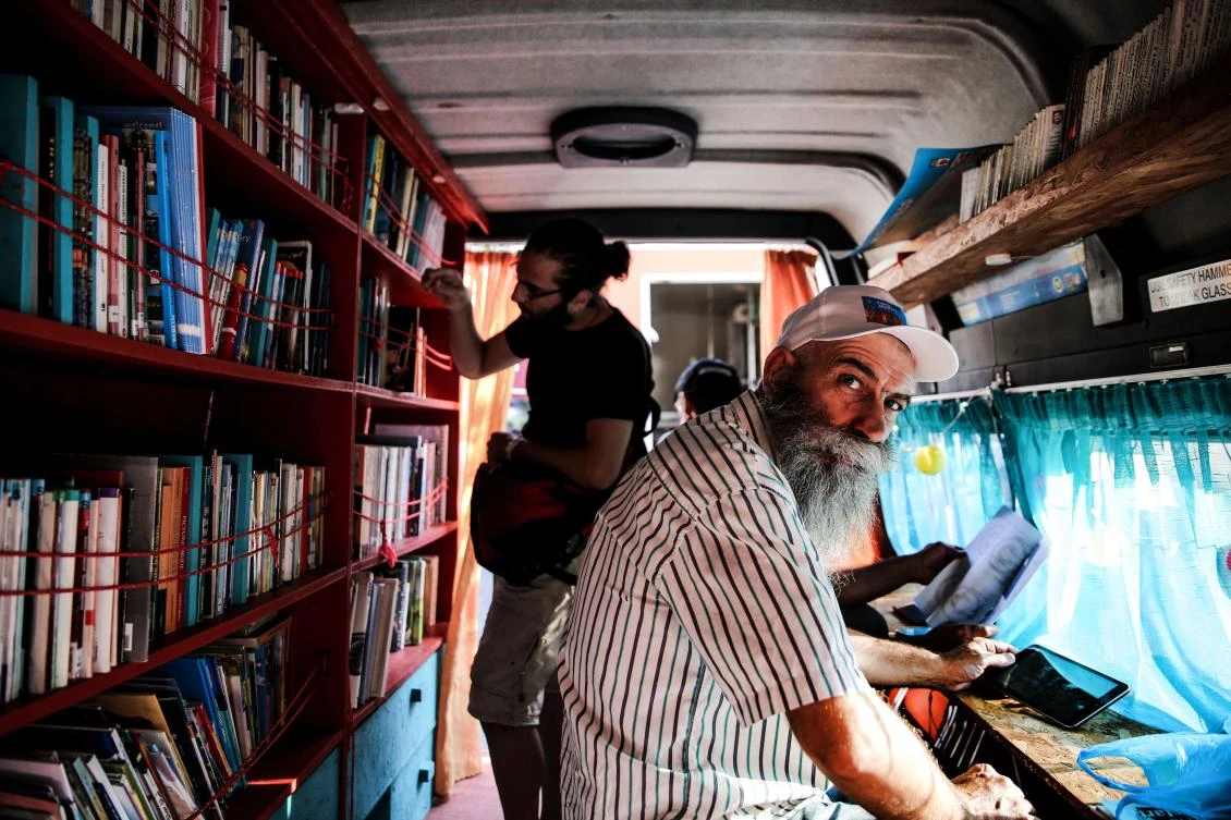 A man looks on as he its inside a library van in central Athens on August 9, 2017. There are increasingly initiatives in Greece to offer reading and books to the tens of thousands of refugees stranded in the country. (AFP)