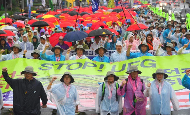 South Korean protesters hold a banner reading "Stop! UFG (Ulchi-Freedom Guardian joint military exercise)" as they march toward the US Embassy during an anti-US rally demanding peace in the Korean Peninsula in Seoul Tuesday. (AFP)