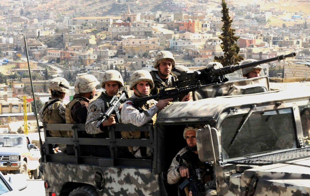 Lebanese army soldiers on their armored vehicle patrol the Sunni Muslim border town of Arsal, in eastern Bekaa Valley, on March 20, 2014. (File Photo by Reuters)