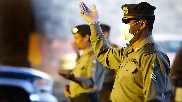 Saudi police officers check passengers and vehicles at a checkpoint on Makkah-Jeddah highway in Makkah. (File photo)