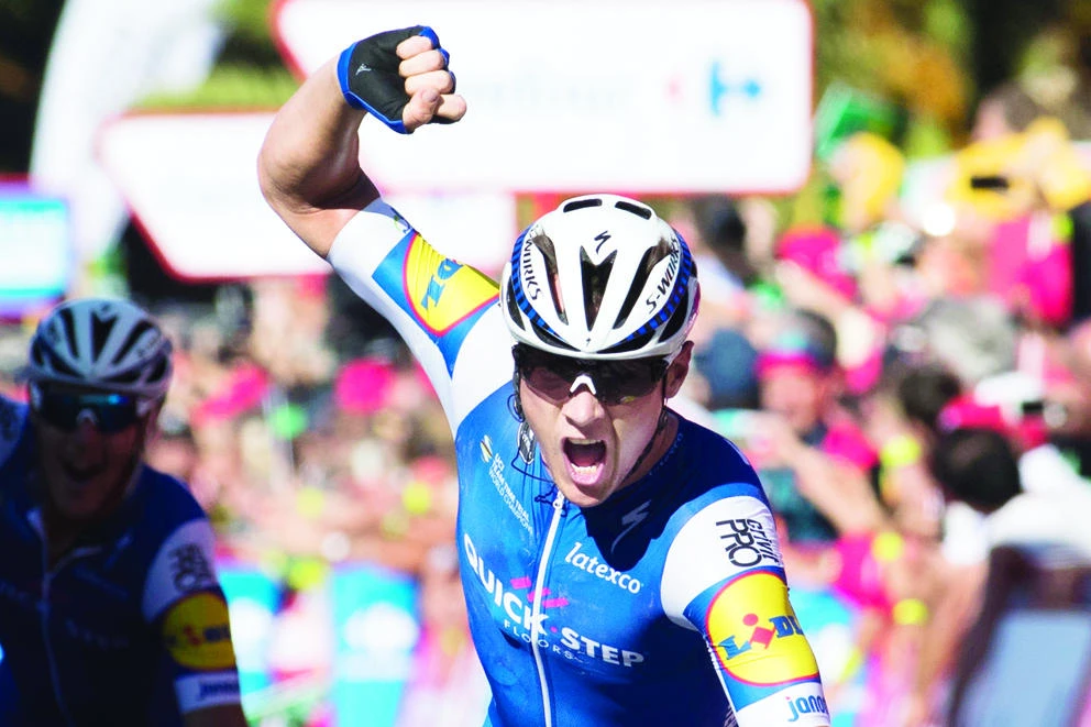 Belgian cyclist Yves Lampaert of Quick-Step Floors celebrates as he crosses the finish line to win the 2nd stage of the 72nd edition of ‘La Vuelta’ Tour of Spain cycling race on Sunday. (AFP)