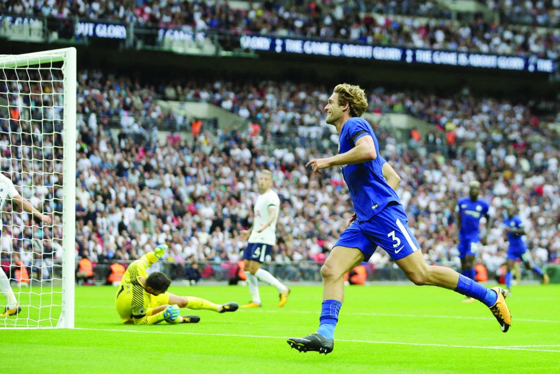 Chelsea’s Spanish defender Marcos Alonso celebrates after scoring their second goal during the English Premier League football match between Tottenham Hotspur and Chelsea at Wembley Stadium on Sunday. (AFP)
