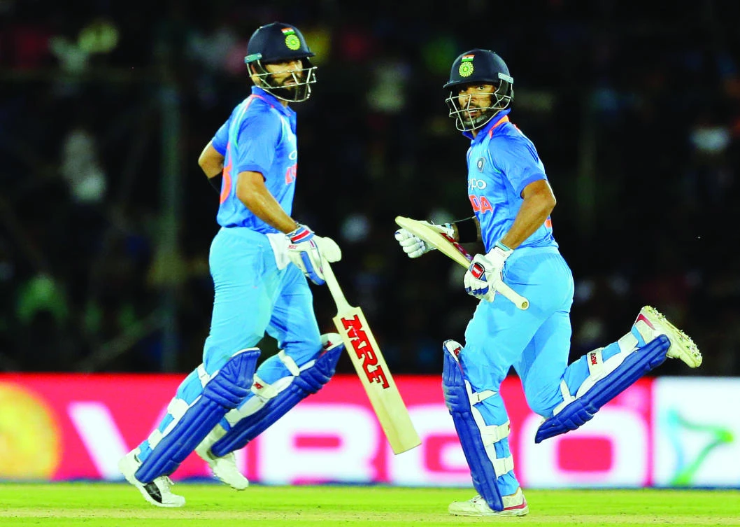 India’s captain Virat Kohli, left, and Shikhar Dhawan run between the wickets during their first one-day international cricket match against Sri Lanka in Dambulla, Sri Lanka. (AP)