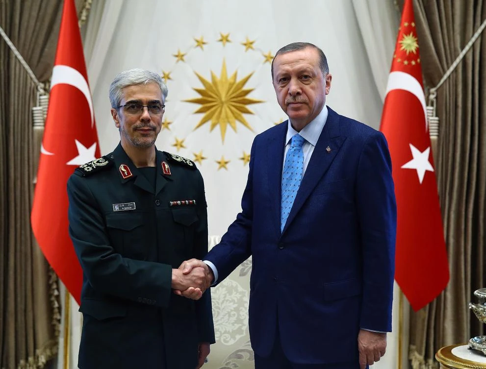 Turkish President Recep Tayyip Erdogan, right, shakings hands with General Staff of Iranian Armed Forces Mohammad Bagheri, in a handout picture by Turkish President’s Press Office, taken on August 16, 2017. (Turkish President’s Office via AFP)