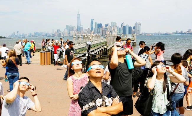 People view the solar eclipse at Liberty State Island in New York on Monday. (Reuters)
