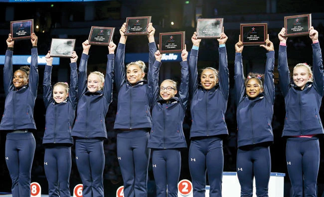 From left, Trinity Thomas, Ragan Smith, Riley McCusker, Ashton Locklear, Morgan Hurd, Margzetta Frazier, Jordan Chiles and Jade Carey celebrate after being named to the US women's gymnastics team Sunday in Anaheim, Calif. (AP)