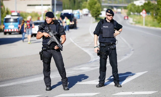 Two armed police officers stand guard near Subirats, Spain, Monday, Aug. 21, 2017. (AP)