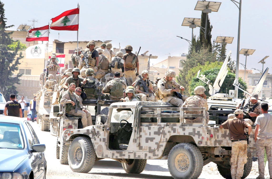 Lebanese soldiers with their military vehicles in the town of Ras Baalbek on Monday. (Reuters)