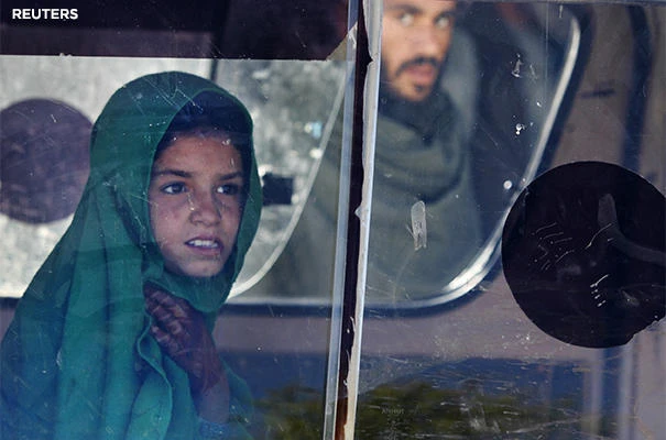 Afghan girl looking at a man from a car's window. (File photo by REUTERS)