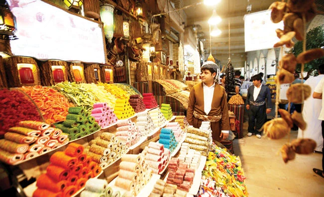 A Kurdish man sells sweets at a market in Irbil, Iraq. (Reuters)