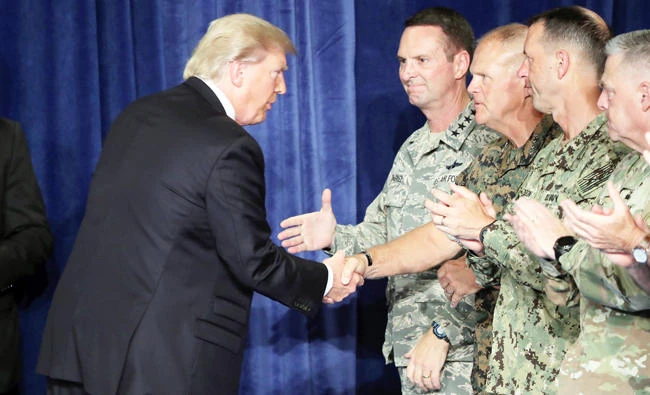 US President Donald Trump greets military leaders before his speech on Afghanistan at the Fort Myer military base on Monday in Arlington, Virginia. (AFP)