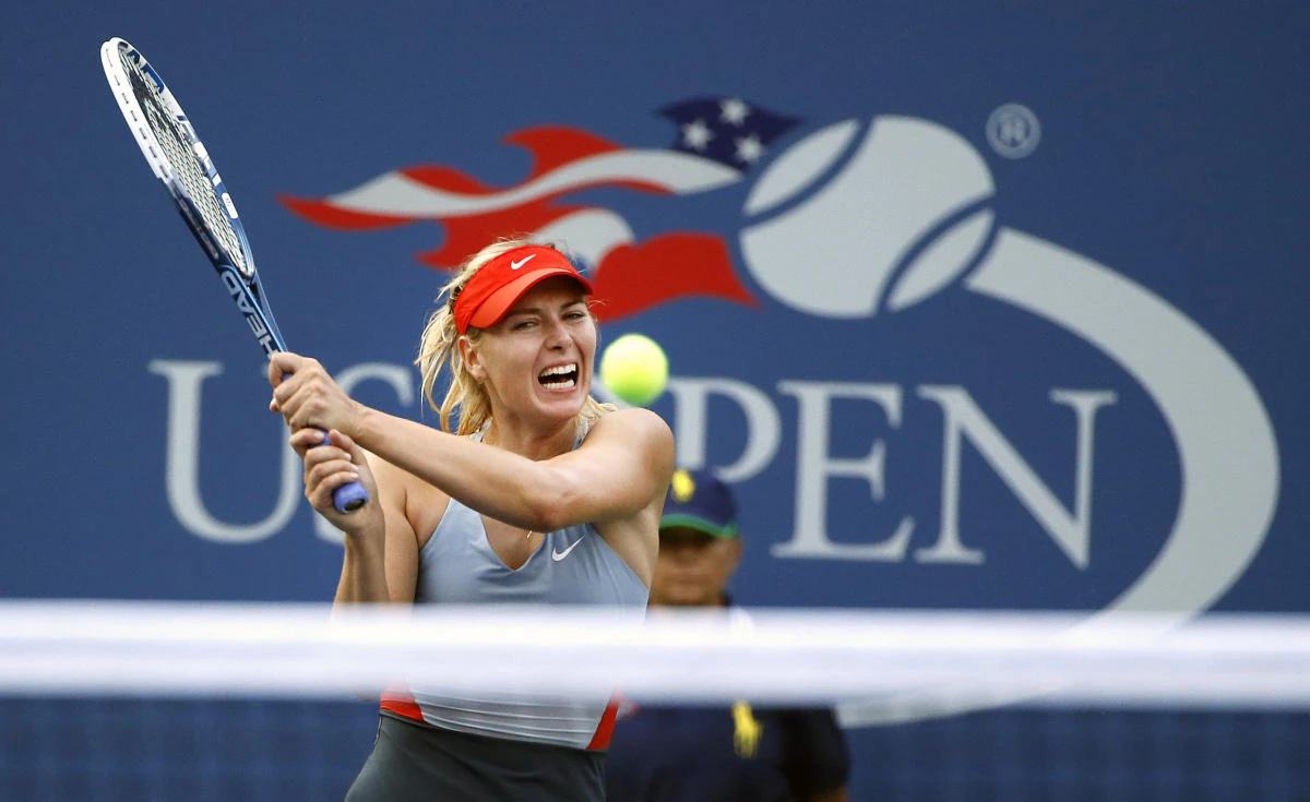 In this file photo, Maria Sharapova, of Russia, returns a shot to Alexandra Dulgheru, of Romania, during the second round of the US Open tennis tournament, in New York, on Aug 27, 2014. (AP)
