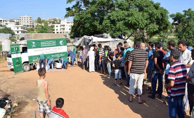 Yemenis join a queue in Taiz, Yemen, to get their share of relief goods from the King Salman Humanitarian Aid and Relief Center (KSRelief) in this June 2017 file photo.