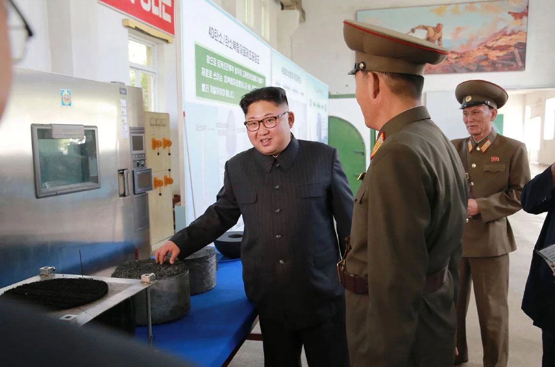 North Korean leader Kim Jong-Un (L) visiting the Chemical Material Institute of the Academy of Defense Science at an undisclosed location. (AFP/ KCNA VIA KNS)