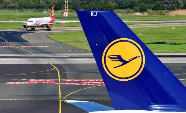 An Airbus operated by German airline 'Air Berlin' rolls on the runway behind an airplane operated by Lufthansa on Wednesday in Duesseldorf, western Germany. (AFP)