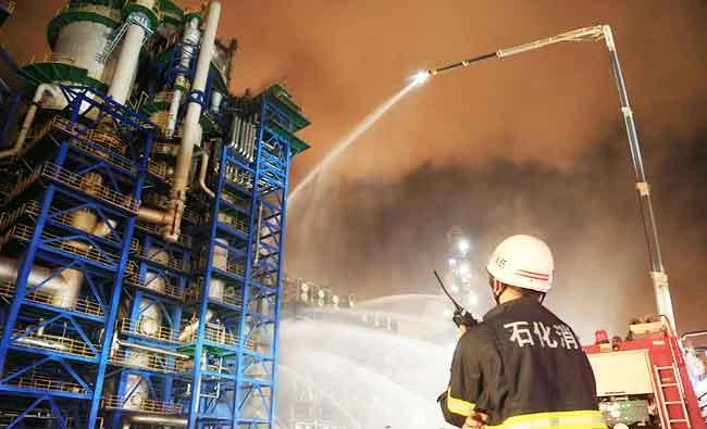 Firefighters spray water onto a fire at state oil major PetroChina's plant in Dalian, Liaoning province, China, in this August 17, 2017 photo. (Reuters)