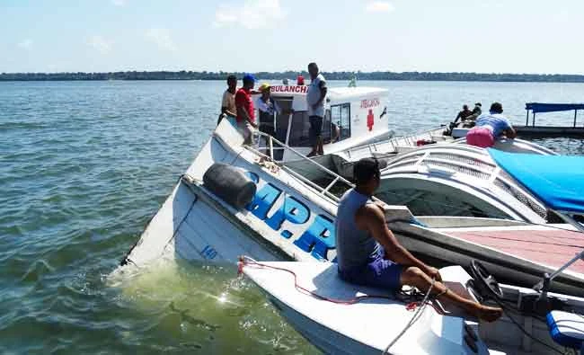 People surround the boat "Comandante Ribeiro" that sank while carrying 70 people during a search and rescue mission in the Xingu River, Para state, Brazil, on Wednesday. (AP)