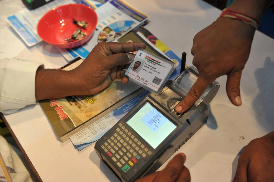 This file photo taken on January 18, 2017 shows an Indian visitor giving a thumb impression to withdraw money from his bank account with his Aadhaar or Unique Identification (UID) card during a Digi Dhan Mela, held to promote digital payment, in Hyderabad. India's Supreme Court ruled August 24 that citizens have a constitutional right to privacy, a landmark verdict that could have wide-reaching implications for the government's biometric programme which holds data on over one billion people. (AFP)
