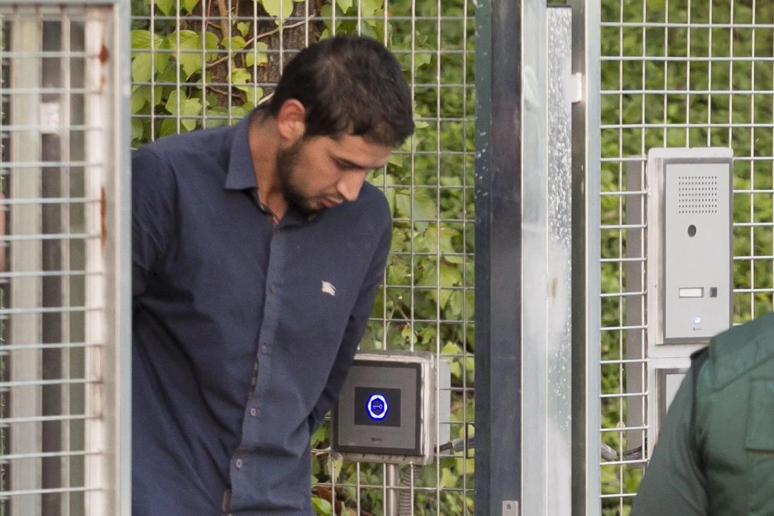 This file photo shows Salh El Karib, suspected of involvement in the terror cell that carried out twin attacks in Spain, escorted by Spanish Civil Guards from a detention center in Tres Cantos, near Madrid, before being tranSferred to the National Court, on August 22, 2017. (AFP)