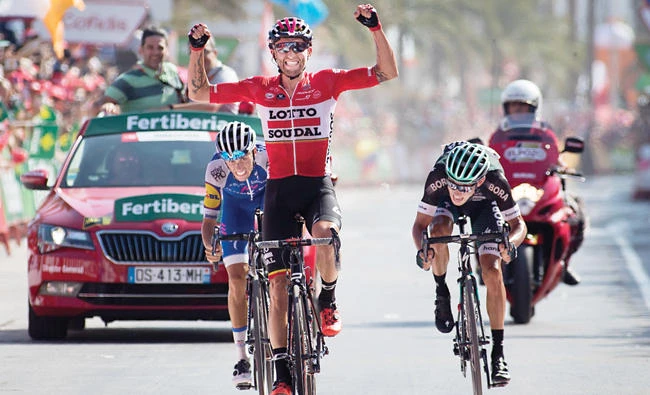Lotto Soudal's Polish cyclist Tomasz Marczynski celebrates as he crosses the finish line to win the 6th stage of the 72nd edition of "La Vuelta" Tour of Spain cycling race on Thursday. (AFP)