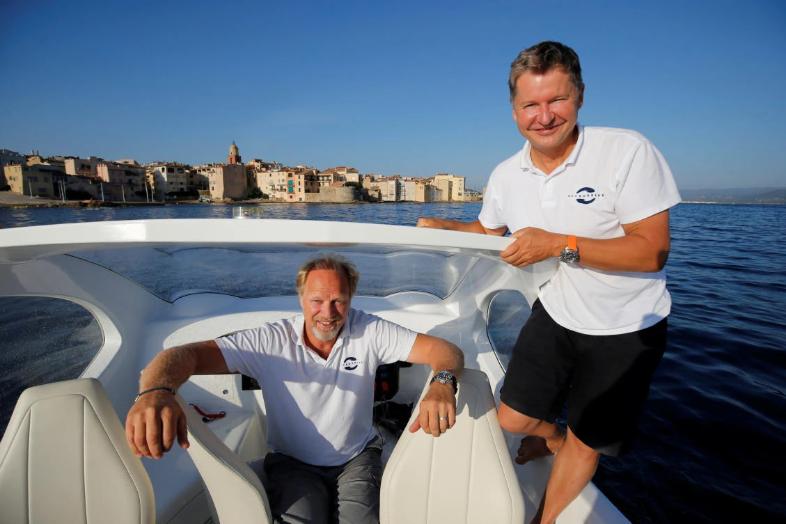 Anders Bringdal (left) and Alain Thebault, founders of French startup SeaBubbles pose aboard a prototype of their water taxi, in the harbour of Saint-Tropez, France. (Reuters)