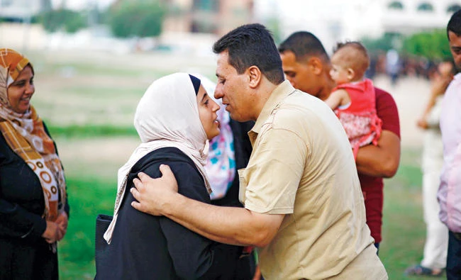 A Palestinian Muslim pilgrim says goodbye to her relatives in Gaza City, as she starts her journey for the annual Hajj pilgrimage in Saudi Arabia’s holy city of Makkah. (AFP)