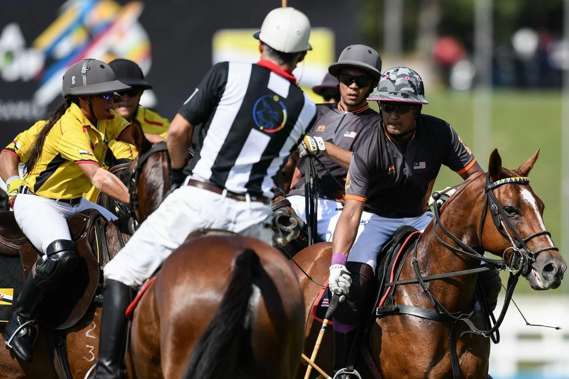 Malaysia's Khairy Jamaluddin Abu Bakar (R) fights for the ball during their equestrian polo match against Brunei at the 29th Southeast Asian Games (SEA Games) in Putrajaya, outside Kuala Lumpur on August 22, 2017. (AFP)