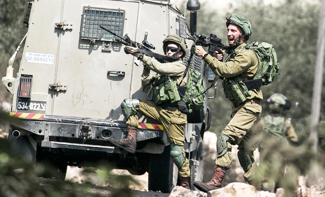 Israeli security forces are pictured during clashes with Palestinian demonstrators following a weekly demonstration against the expropriation of Palestinian land by Israel in the village of Kfar Qaddum, near Nablus in the occupied West Bank, on Friday. (AFP)