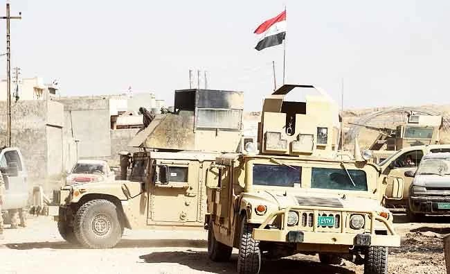 Humvees and vehicles of the combined Iraqi forces and Hashed Al-Shaabi (Popular Mobilization units) advance inside the town of Tal Afar, west of Mosul, after the Iraqi government announced the launch of the operation to retake it from Daesh group control, on Friday. (AFP)