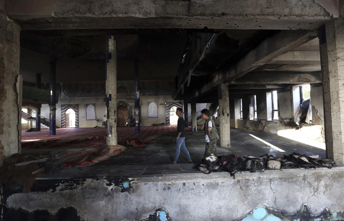 Afghan boys are seen inside a Shiite mosque where gunmen attacked during Friday prayers, in Kabul, Afghanistan, on Aug 26, 2017. (AP)