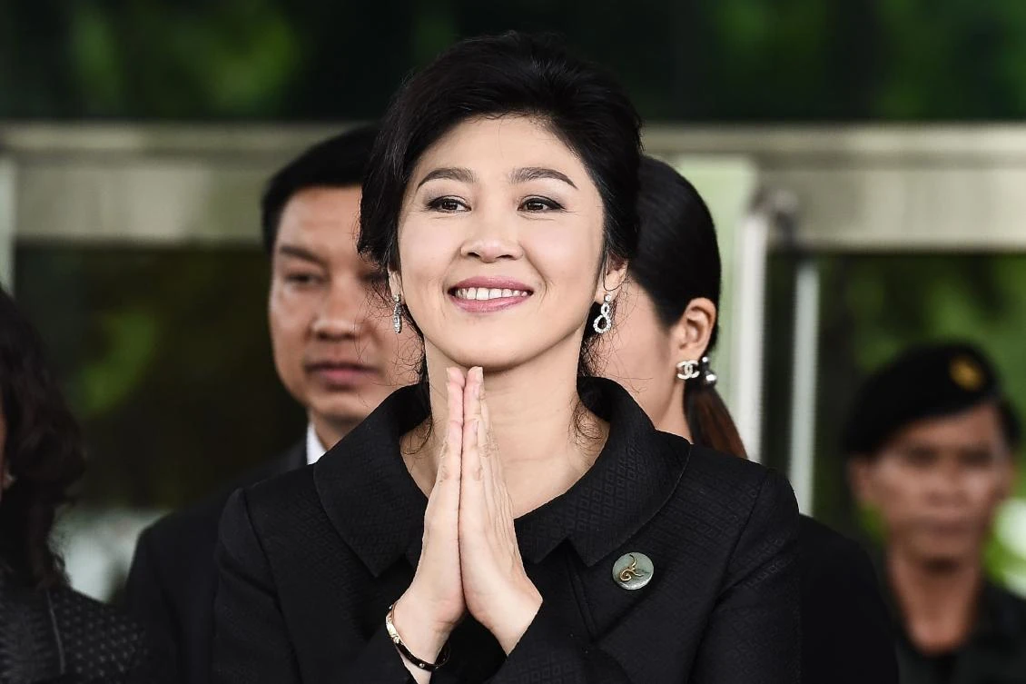 This file photo taken on July 21, 2017 shows former Thai prime minister Yingluck Shinawatra greeting her supporters as she leaves the Supreme Court in Bangkok. Thai ex-prime minister Yingluck Shinawatra missed a verdict in a negligence trial on August 25, 2017 that could have seen her jailed, prompting the Supreme Court to issue an arrest warrant fearing she is a flight risk, a judge said. (AFP)