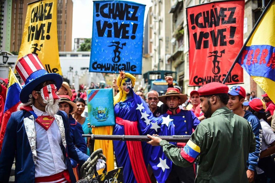 Pro-government activists representing a Venezuelan Bolivarian revolutionary (R) and US' Uncle Sam (L) perform during a demonstration to support President Nicolas Maduro, in Caracas, on August 14, 2017. The United States vowed Monday to stop Venezuela from becoming a "failed state," as it rallied Latin American allies after President Donald Trump warned of possible military action. (AFP)