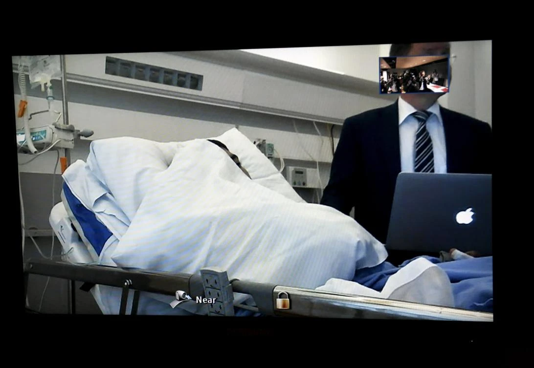 Seen on a court video link screen, Moroccan man Abderrahman Mechkah, lays in a hospital bed during the initial remand hearing, on suspicion of murder, attempted murder, and terrorism crimes, at court in Turku, Finland, on Aug 22, 2017. (File photo by Lehtikuva via AP)