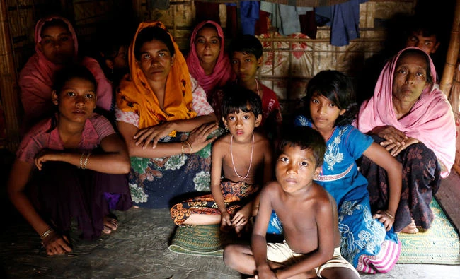 A group of Rohingya refugees takes shelter at the Kutuupalang makeshift refugee camp, after crossing the Myanmar-Bangladesh border in Coxâs Bazar, Bangladesh on Saturday. (Reuters)
