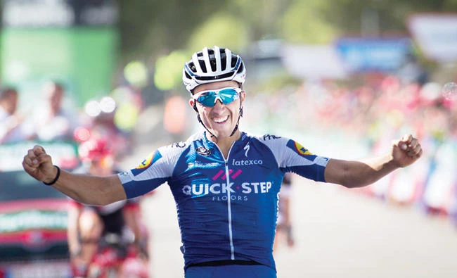 Quick-Step Floors Team's French cyclist Julian Alaphilippe celebrates as he crosses the finish line to win the 8th stage of the 72nd edition of "La Vuelta" Tour of Spain cycling race on Saturday. (AFP)