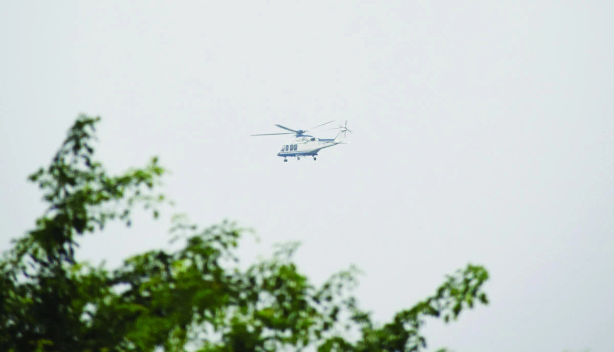 A helicopter believed to be transporting leader of Dera Sacha Sauda sect, who calls himself Saint Dr. Gurmeet Ram Rahim Singh Ji Insaan, flies over Rohtak, India, Friday. (AP)