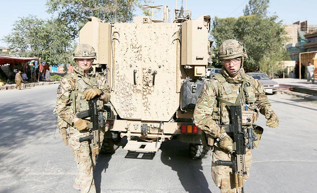 NATO soldiers arrive at the site of a suicide attack followed by a clash between Afghan forces and insurgents after an attack on a Shi'ite mosque in Kabul, Afghanistan, on Friday. (REUTERS)